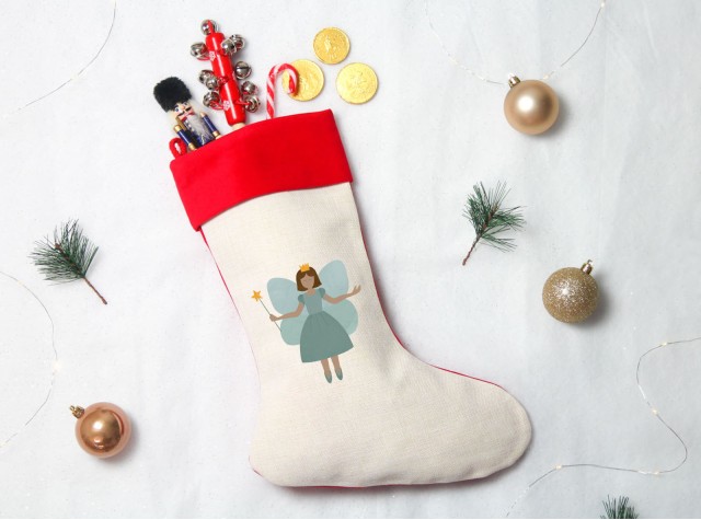 linen and green velvet feel christmas stocking with a design of a fairy
